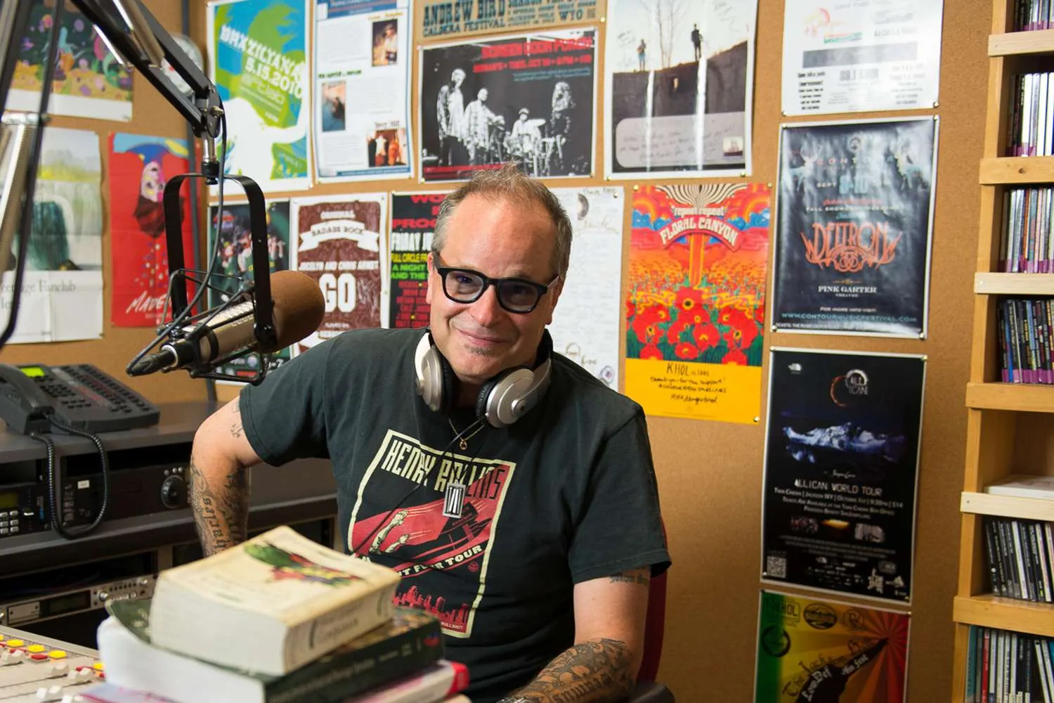 Chef Jason, radio host in a studio, surrounded by music posters and equipment, showcasing culinary expertise and engagement with the audience.