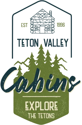 Teton Valley Cabins logo featuring a cabin illustration, established date 1998, and the tagline "Explore the Tetons" with pine trees and mountains.